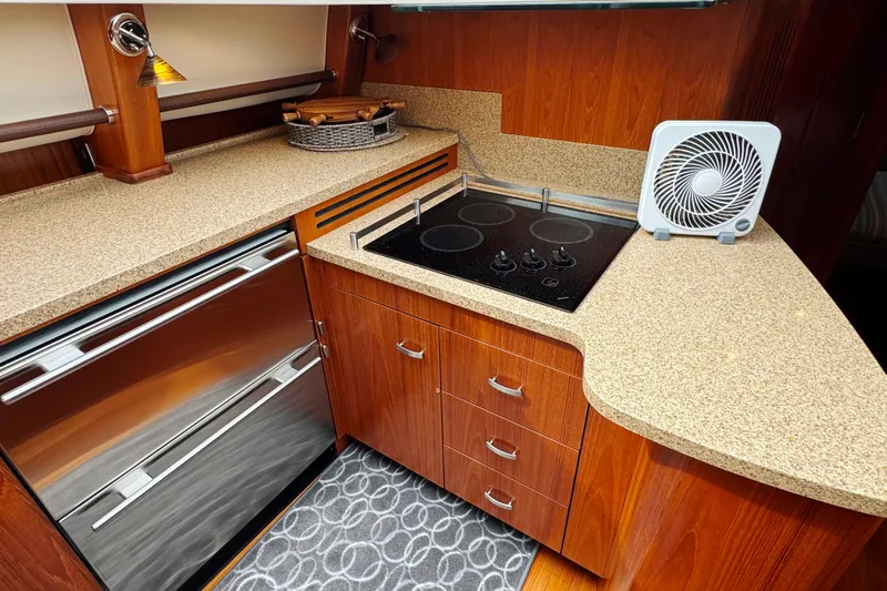  Yacht Photos Pics Luxurious 2014 Tiara Yachts 5800 Sovran kitchen with modern appliances and elegant wood cabinetry.