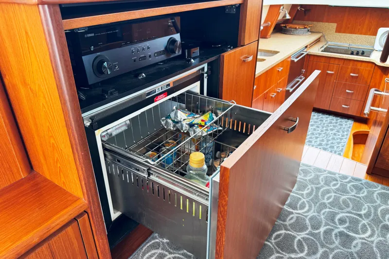  Yacht Photos Pics 2014 Tiara Yachts 5800 Sovran kitchen with open drawer and audio system.