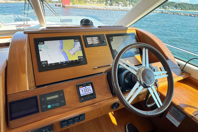  Yacht Photos Pics Helm of 2014 Tiara Yachts 5800 Sovran with navigation screens and steering wheel.