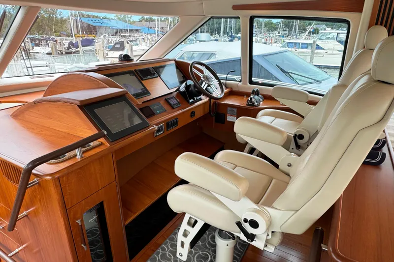  Yacht Photos Pics 2014 Tiara Yachts 5800 Sovran helm with leather seats and advanced navigation systems.