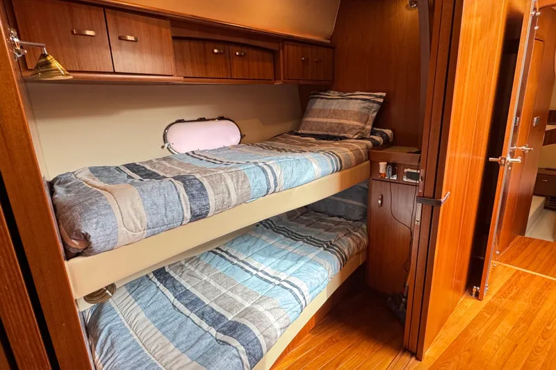  Yacht Photos Pics 2014 Tiara Yachts 5800 Sovran cabin with wooden interior and bunk beds.
