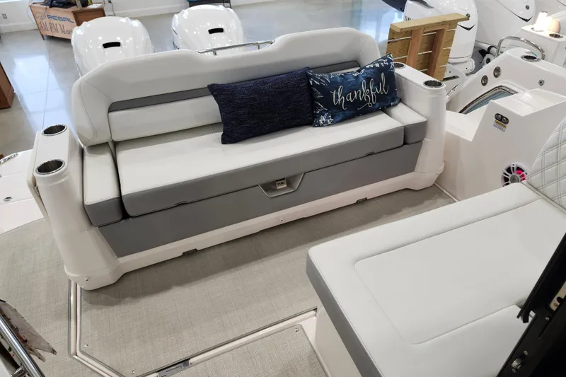  Yacht Photos Pics 2025 Regal 36 XO boat interior with cushioned seating and decorative pillows.