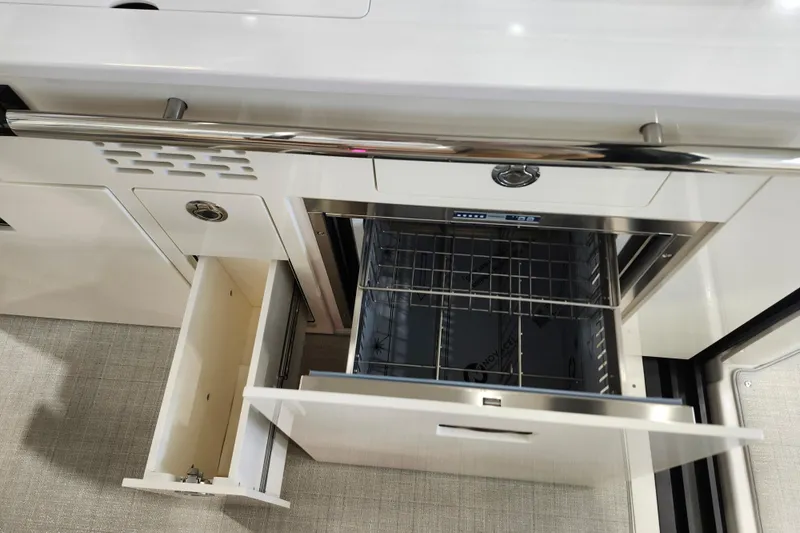  Yacht Photos Pics 2025 Regal 36 XO yacht kitchen with open drawers and stainless steel appliances.