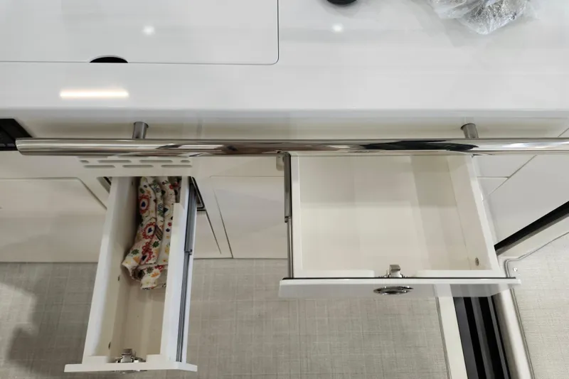  Yacht Photos Pics Open drawers in the 2025 Regal 36 XO yacht kitchen interior.