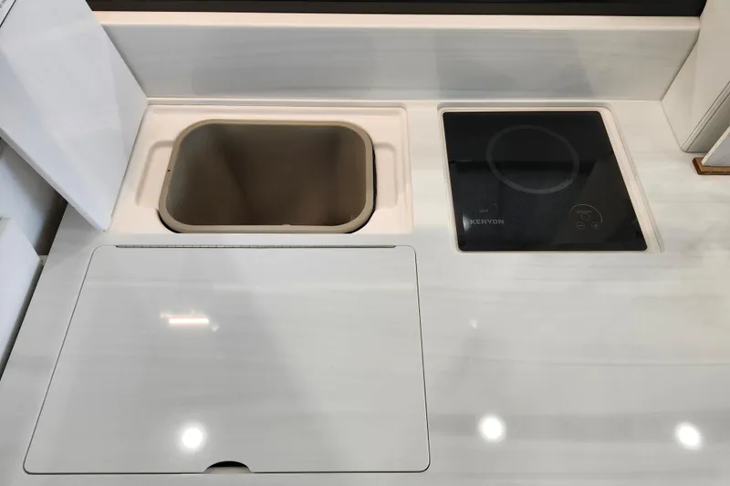  Yacht Photos Pics Modern kitchen area in 2025 Regal 36 XO boat with sink and Kenyon cooktop.