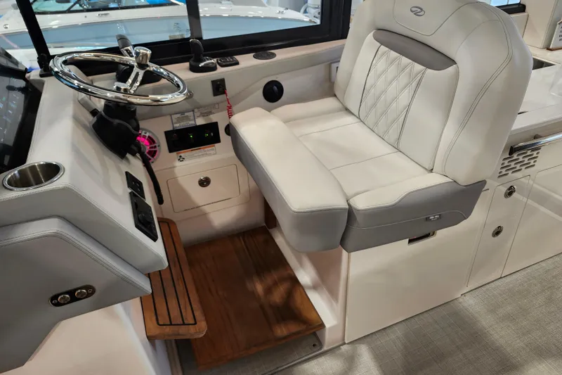  Yacht Photos Pics Captain's seat and helm of 2025 Regal 36 XO boat, featuring modern controls and luxurious design.