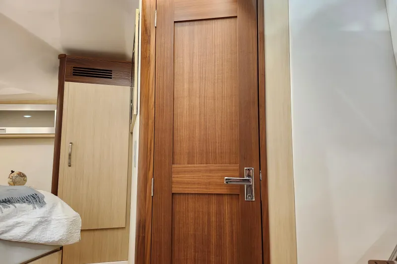  Yacht Photos Pics Interior of 2025 Regal 36 XO yacht featuring wooden door and modern furnishings.