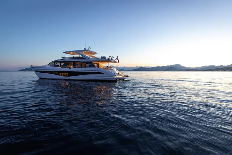  Yacht Photos Pics Luxurious 2026 Princess Y80 yacht cruising at sunset on serene waters.