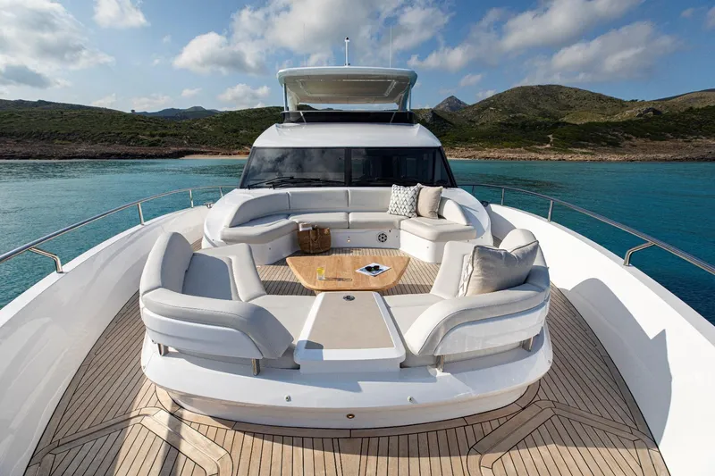  Yacht Photos Pics Luxurious 2026 Princess Y80 yacht with elegant deck seating, cruising in serene blue waters.
