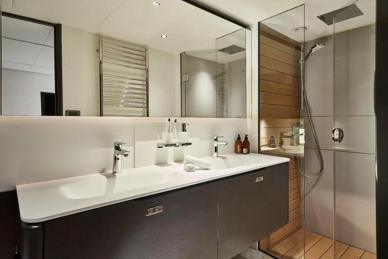  Yacht Photos Pics Luxurious bathroom in 2026 Princess Y80 yacht with modern fixtures and glass shower.