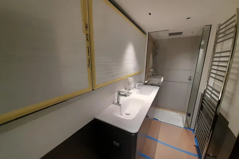  Yacht Photos Pics Modern bathroom in 2026 Princess Y80 yacht with dual sinks and glass shower.