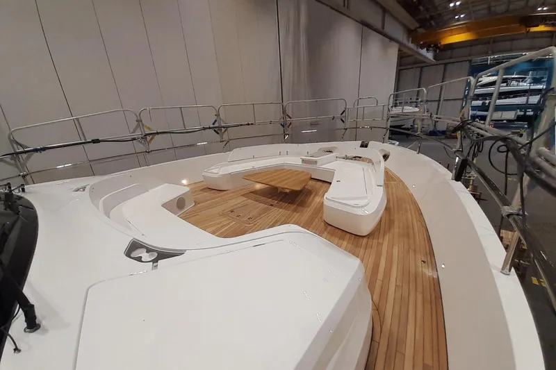  Yacht Photos Pics Luxurious 2026 Princess Y80 yacht deck with elegant seating and wooden flooring.