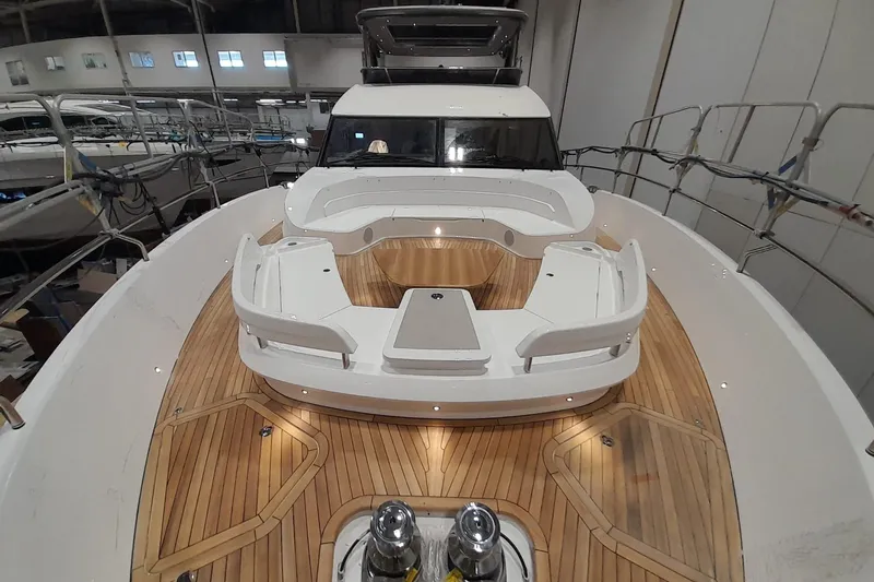  Yacht Photos Pics Luxurious 2026 Princess Y80 yacht with elegant teak deck and spacious seating area.
