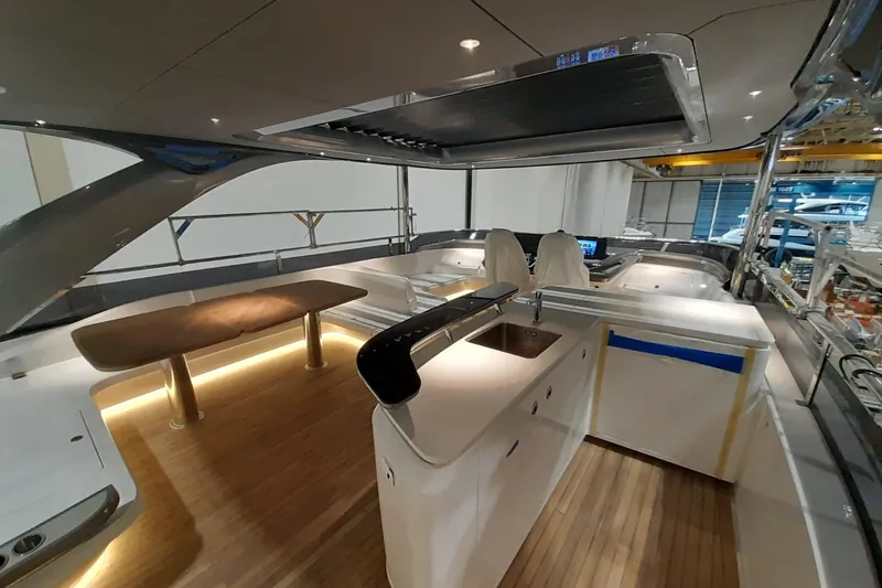  Yacht Photos Pics Luxurious interior of 2026 Princess Y80 yacht with modern kitchen and seating area.