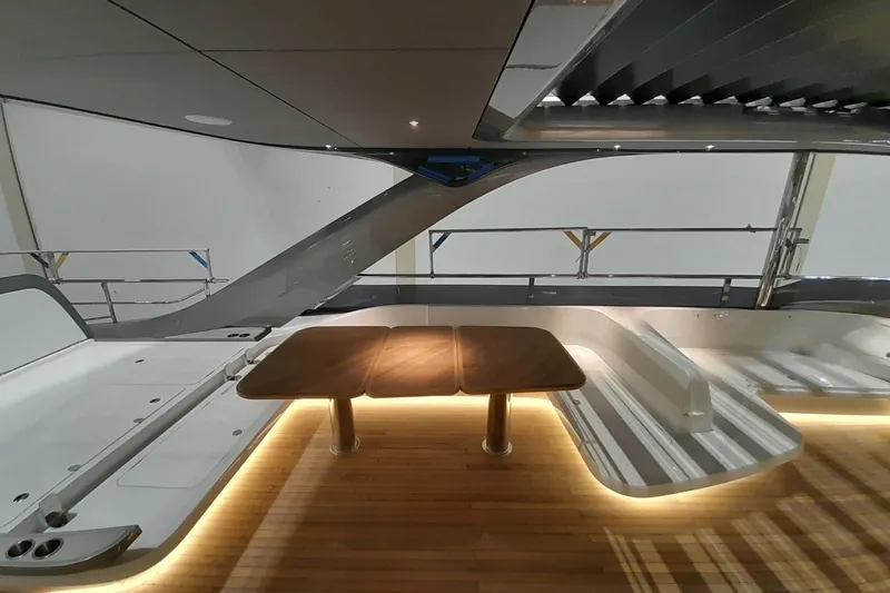  Yacht Photos Pics Luxurious interior of 2026 Princess Y80 yacht with elegant wooden table and ambient lighting.
