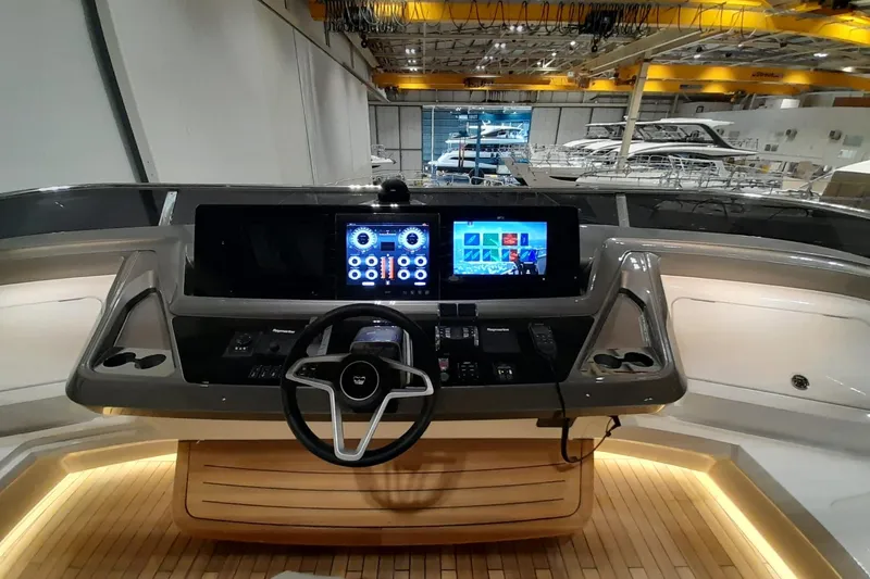  Yacht Photos Pics Helm of 2026 Princess Y80 yacht with modern navigation displays in a showroom.