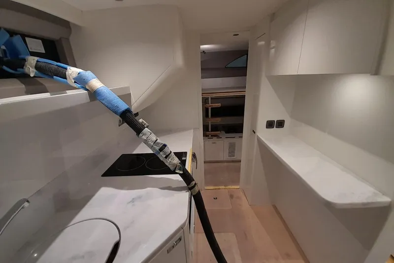  Yacht Photos Pics Interior of 2026 Princess Y80 yacht, featuring modern kitchen and sleek design elements.