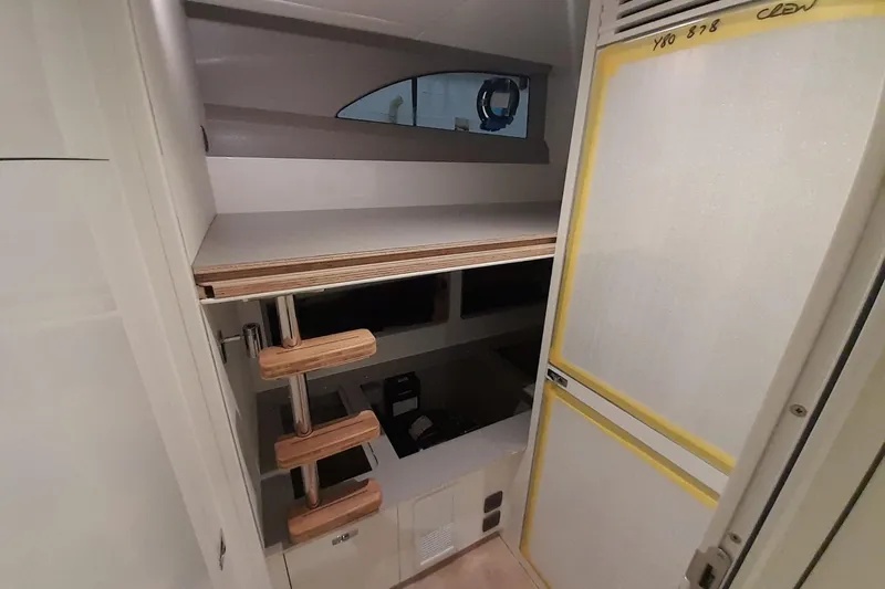  Yacht Photos Pics Interior of 2026 Princess Y80 yacht with wooden steps and storage area.