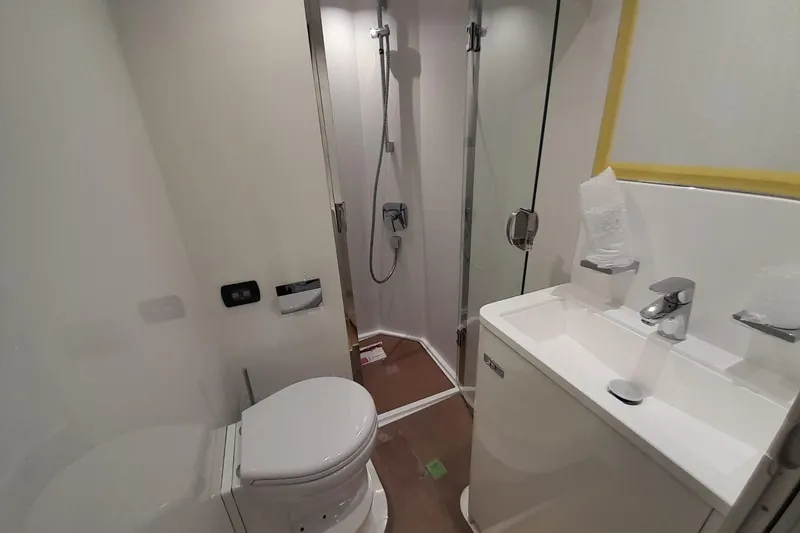 Yacht Photos Pics Modern bathroom in 2026 Princess Y80 yacht with shower, toilet, and sink.