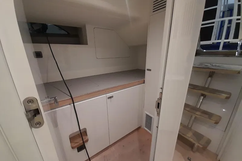  Yacht Photos Pics Interior of 2026 Princess Y80 yacht, featuring compact storage and wooden steps.