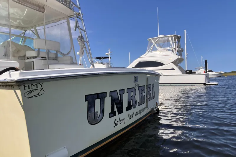 Unreel Yacht Photos Pics 2001 Cabo 31 Express boat named "Unreel" docked in sunny marina.