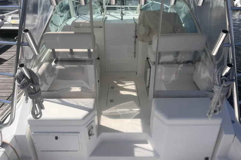 Unreel Yacht Photos Pics 2001 Cabo 31 Express boat interior with seating and fishing rod holders.