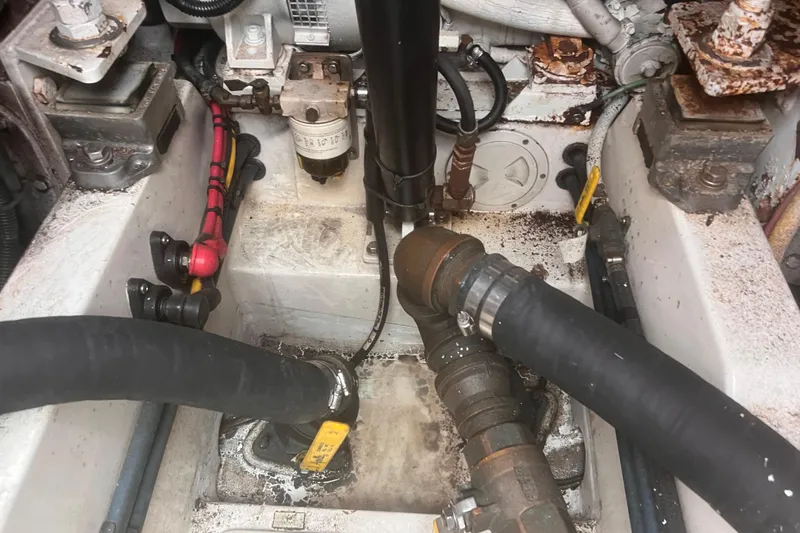 Unreel Yacht Photos Pics Engine compartment of a 2001 Cabo 31 Express boat, showing hoses and mechanical components.