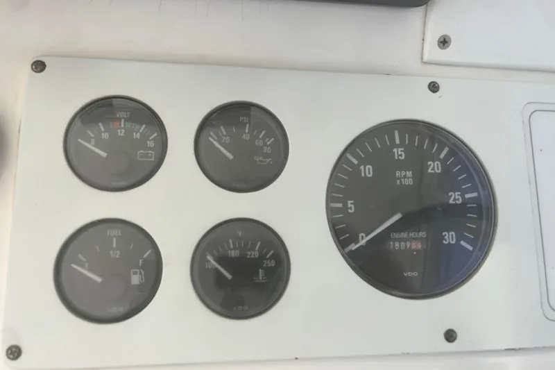 Unreel Yacht Photos Pics Instrument panel of a 2001 Cabo 31 Express boat showing gauges and RPM meter.