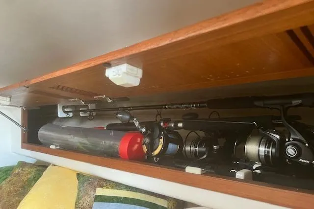 Unreel Yacht Photos Pics Storage compartment in 2001 Cabo 31 Express boat with fishing rods and gear.