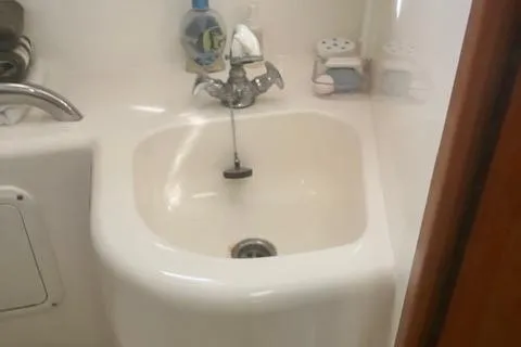 Unreel Yacht Photos Pics 2001 Cabo 31 Express boat sink with faucet and toiletries.