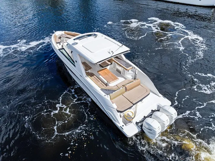  Yacht Photos Pics 2019 Sea Ray SLX 400 OB boat cruising on water, featuring spacious deck and triple outboard engines.
