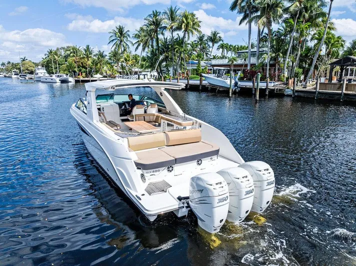  Yacht Photos Pics 2019 Sea Ray SLX 400 OB cruising on a scenic waterway with palm trees.