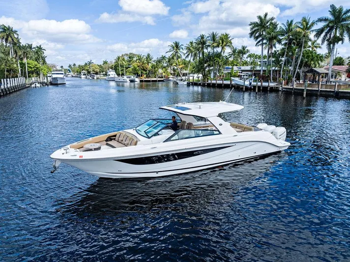  Yacht Photos Pics 2019 Sea Ray SLX 400 OB cruising on a scenic, palm-lined waterway.
