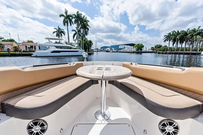 Yacht Photos Pics 2019 Sea Ray SLX 400 OB boat interior with seating and table, docked by palm trees.
