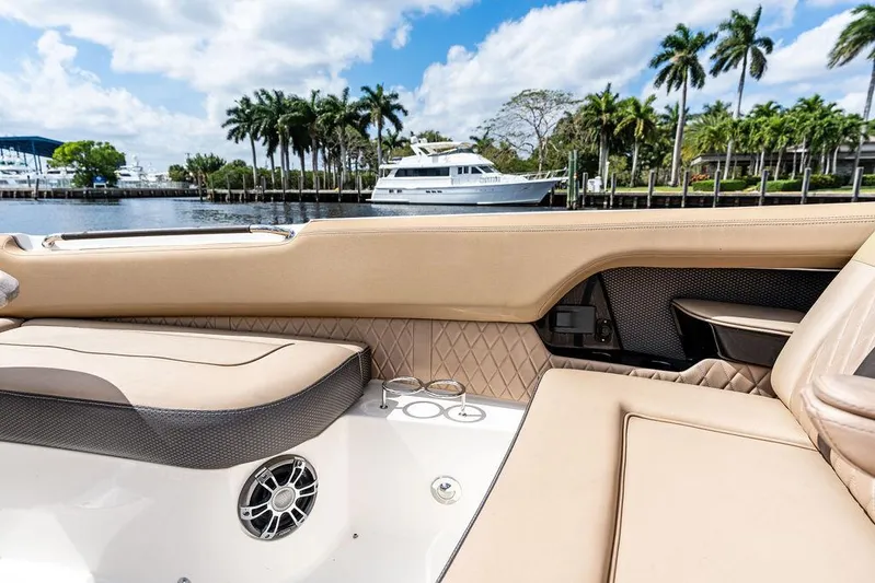  Yacht Photos Pics 2019 Sea Ray SLX 400 OB interior with luxurious seating, docked near palm trees and yachts.