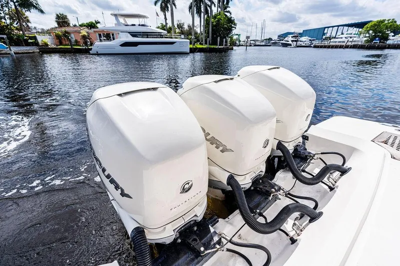  Yacht Photos Pics 2019 Sea Ray SLX 400 OB with triple Mercury outboard engines on a calm waterfront.