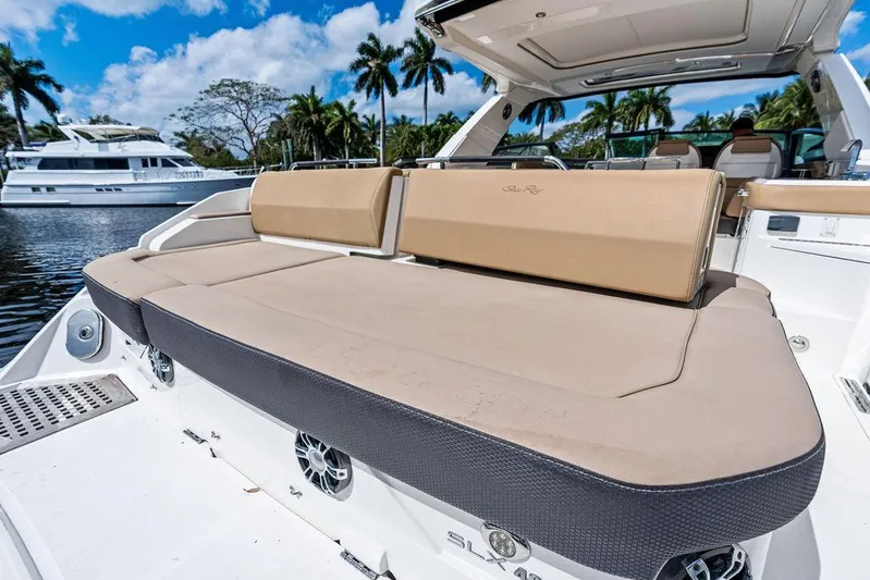  Yacht Photos Pics 2019 Sea Ray SLX 400 OB luxury boat with spacious sunbed and scenic marina backdrop.