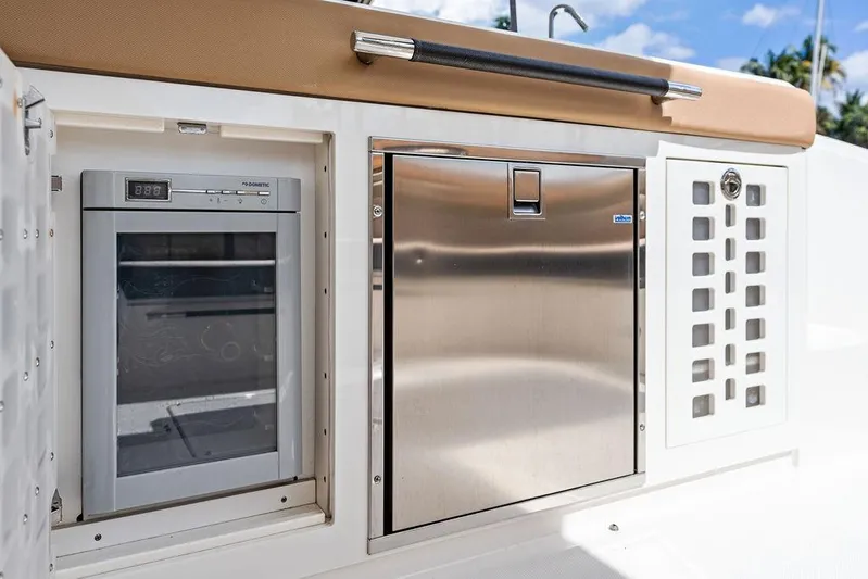  Yacht Photos Pics 2019 Sea Ray SLX 400 OB boat galley with fridge and stainless steel storage.