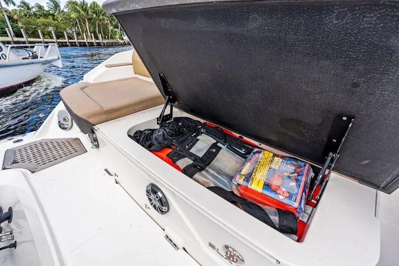  Yacht Photos Pics Storage compartment on a 2019 Sea Ray SLX 400 OB boat, open with safety gear inside.