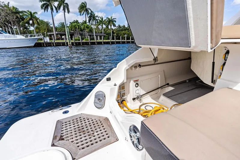  Yacht Photos Pics 2019 Sea Ray SLX 400 OB boat interior with open storage, near waterfront and palm trees.