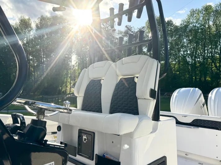  Yacht Photos Pics 2024 Tidewater 292 CC Adventure boat interior with dual seats, steering wheel, and sunlight.