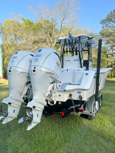  Yacht Photos Pics 2024 Tidewater 292 CC Adventure boat with dual engines, parked on grass.