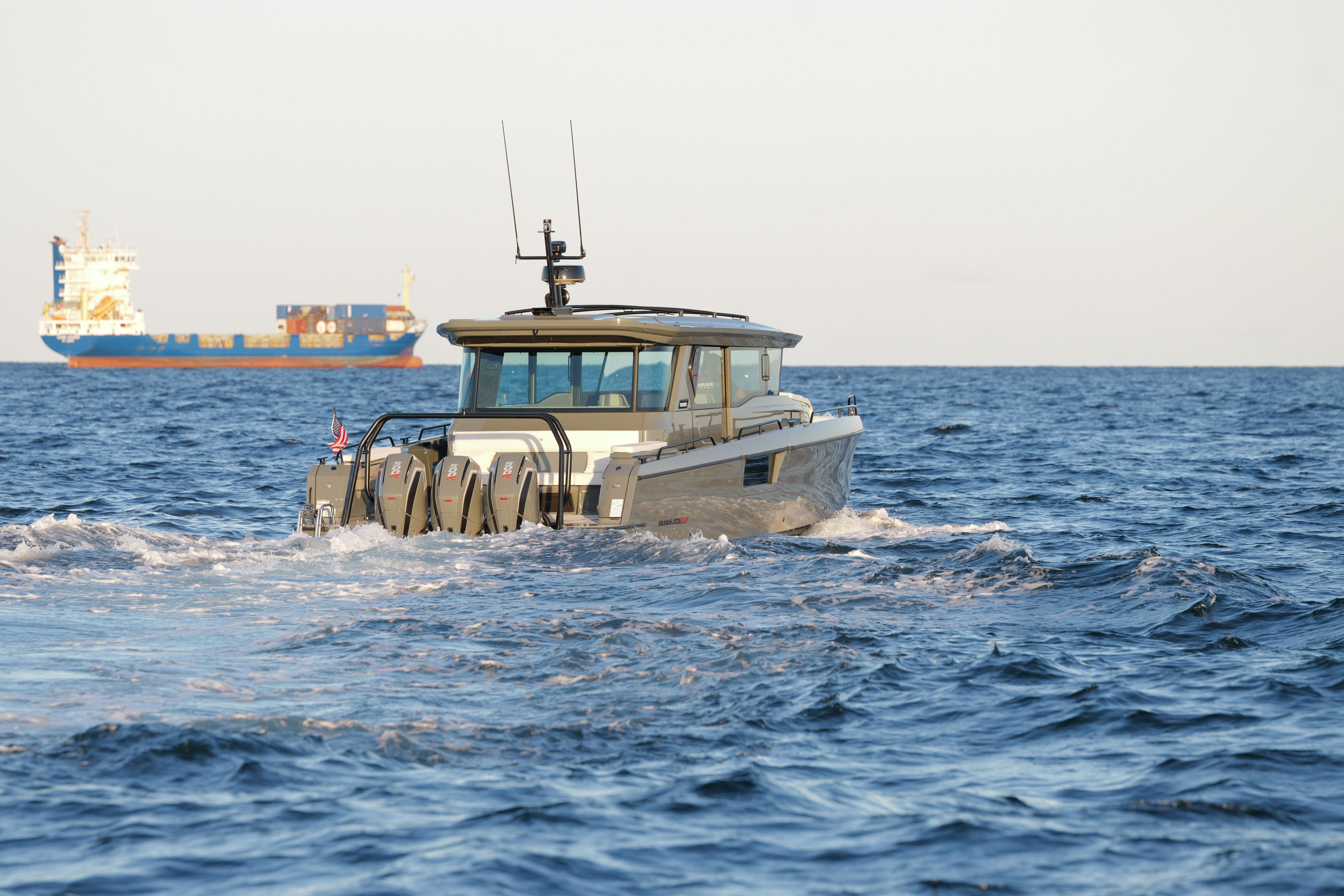 2026 BRABUS 1500 boat cruising on open sea with cargo ship in background.