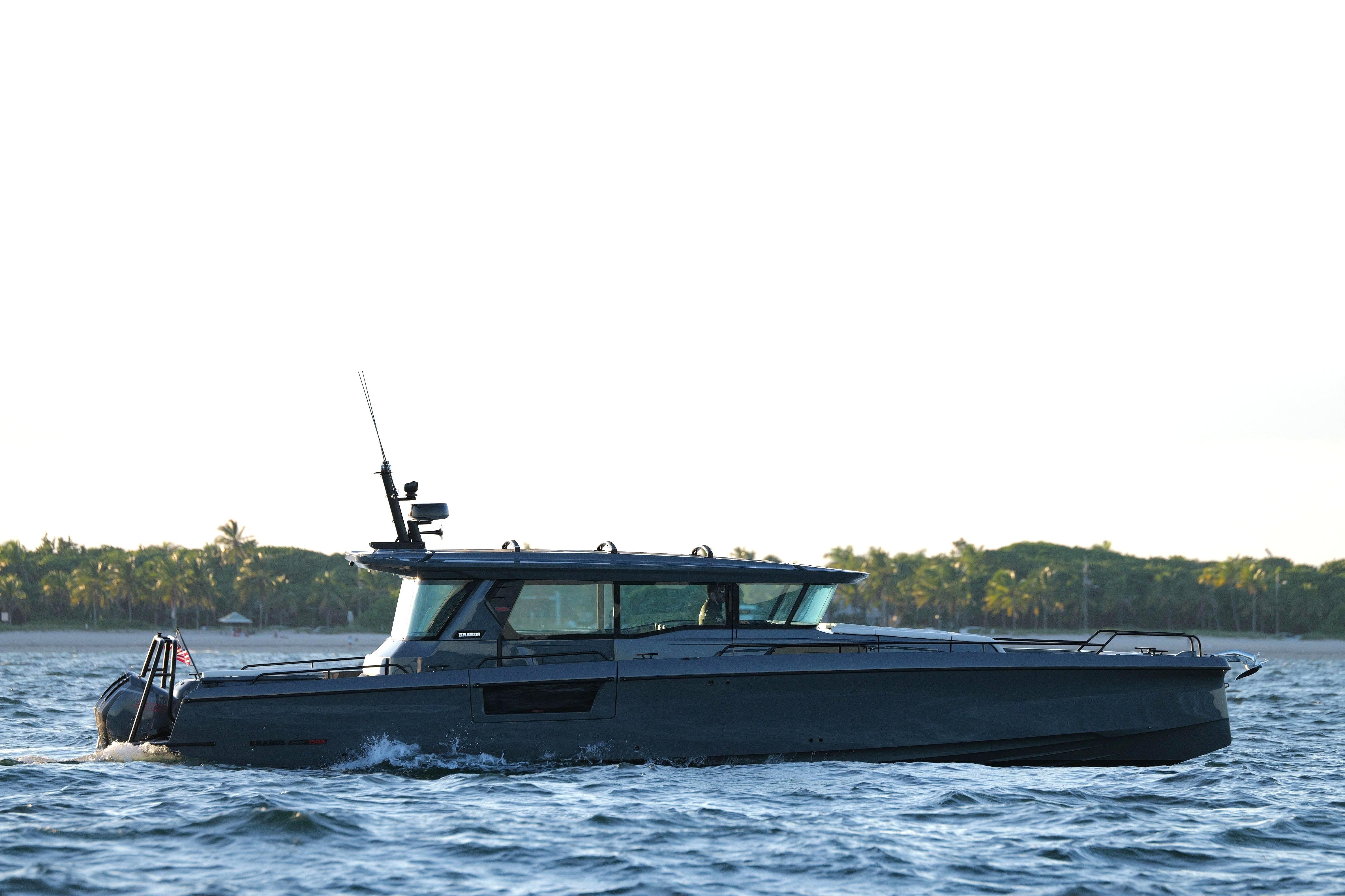 2026 BRABUS 1500 yacht cruising near a tropical shoreline.