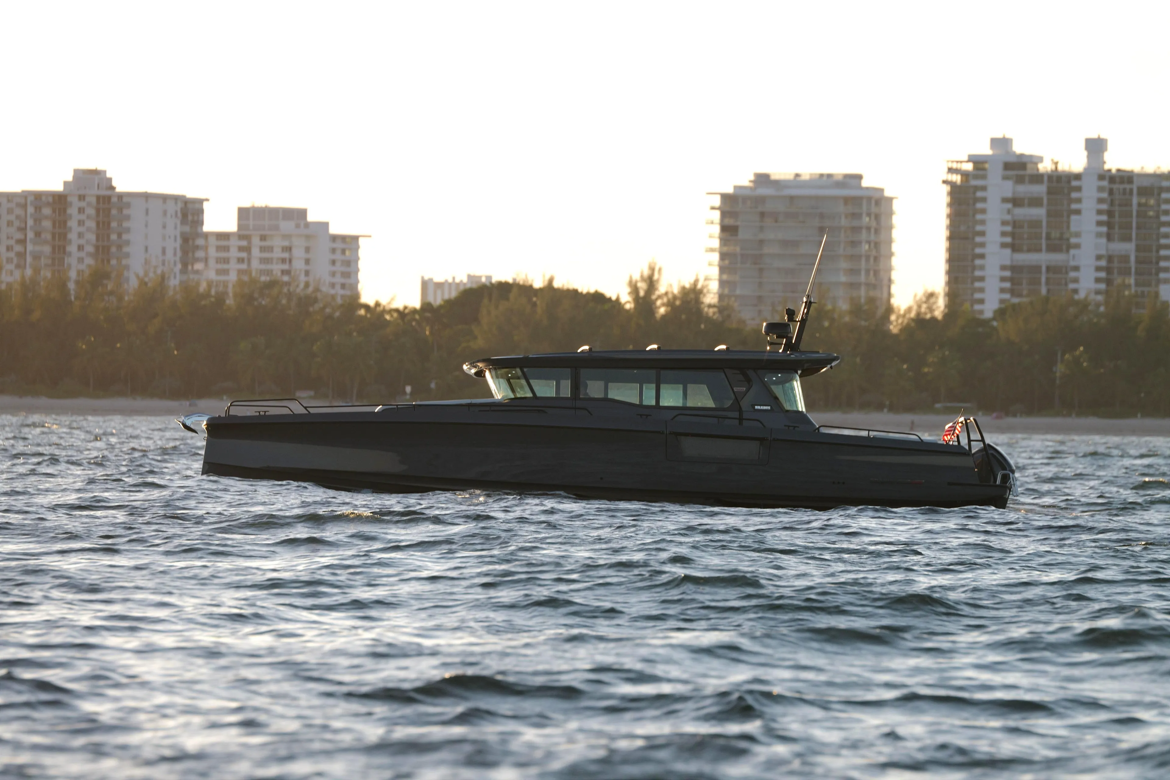2026 BRABUS 1500 yacht cruising on water with city skyline in background.