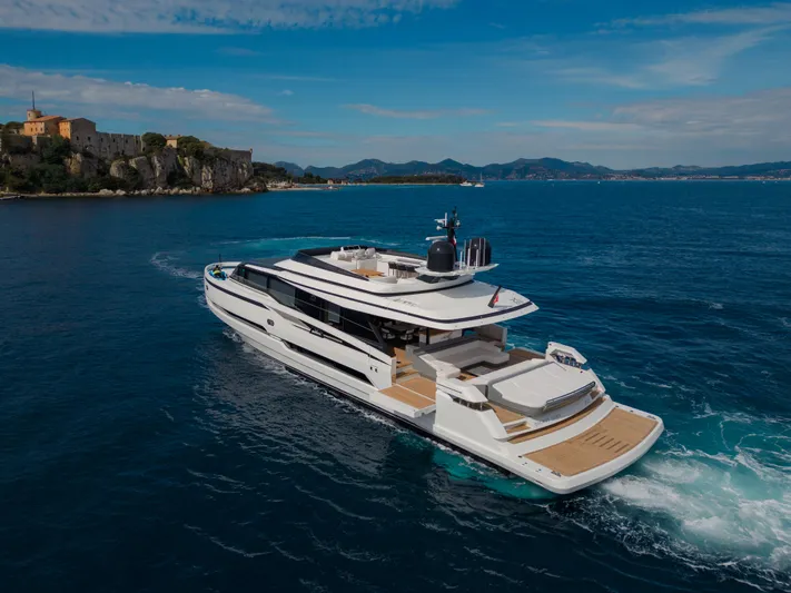 X99 Fast Yacht Photos Pics Luxury yacht Extra X99 FAST 2026 cruising near a coastal fortress.