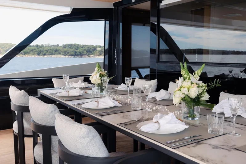 X99 Fast Yacht Photos Pics Luxurious dining area on Extra X99 FAST yacht, 2026 model, with elegant table setting and ocean view.