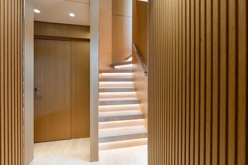 X99 Fast Yacht Photos Pics Modern wooden staircase with ambient lighting in Extra X99 FAST yacht, 2026 model.