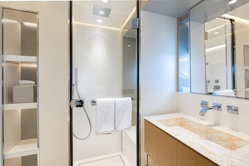 X99 Fast Yacht Photos Pics Modern bathroom with glass shower, marble sink, and sleek shelving in Extra X99 FAST 2026 model.