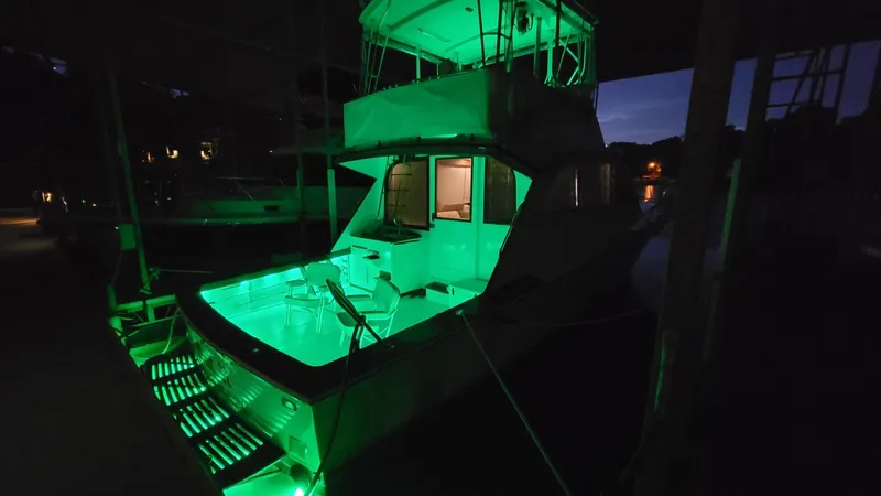  Yacht Photos Pics 1984 Post 43 Sport Fisherman boat with green deck lights at night.